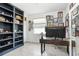 Bright home office featuring built-in shelves, modern desk, and decorative wall art at 31426 Ancient Sage Rd, Wesley Chapel, FL 33545