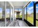 Enclosed sunroom with stylish seating, perfect for enjoying the outdoors in comfort at 31426 Ancient Sage Rd, Wesley Chapel, FL 33545