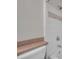 Cozy bathroom featuring a tiled shower, tub, and toilet with a wooden shelf for added convenience at 36243 Lake Chase Blvd # 102, Zephyrhills, FL 33541