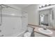 Clean bathroom with white tile, a shower-tub combination, and modern fixtures at 36243 Lake Chase Blvd # 102, Zephyrhills, FL 33541