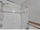 Clean bathroom featuring a shower and tub combination with a white tiled surround at 36243 Lake Chase Blvd # 102, Zephyrhills, FL 33541