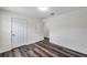 Bedroom featuring wood-look floors, with closet and doorways to other rooms at 36243 Lake Chase Blvd # 102, Zephyrhills, FL 33541