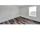 Bedroom featuring wood-look floors and a window that provides ample natural light at 36243 Lake Chase Blvd # 102, Zephyrhills, FL 33541