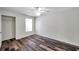 Minimalist bedroom with wood-look floors, a ceiling fan, and ample natural light at 36243 Lake Chase Blvd # 102, Zephyrhills, FL 33541
