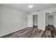 Bedroom showcasing wood-look floors, a closet, and doorway access to a bathroom at 36243 Lake Chase Blvd # 102, Zephyrhills, FL 33541