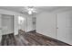 Cozy bedroom featuring wood-look floors, a ceiling fan, and easy access to the bathroom and closet at 36243 Lake Chase Blvd # 102, Zephyrhills, FL 33541
