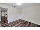 Bedroom featuring wood-look floors, and doorway access to other rooms in home at 36243 Lake Chase Blvd # 102, Zephyrhills, FL 33541