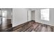 Spacious bedroom with wood-look flooring, a closet, and a bright, airy atmosphere at 36243 Lake Chase Blvd # 102, Zephyrhills, FL 33541