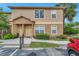 Inviting tan condo exterior featuring a quaint, covered entryway and well-manicured landscaping at 36243 Lake Chase Blvd # 102, Zephyrhills, FL 33541