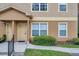 Inviting tan condo exterior featuring a quaint, covered entryway and well-manicured landscaping at 36243 Lake Chase Blvd # 102, Zephyrhills, FL 33541