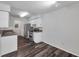 White kitchen with stainless steel appliances boasts hardwood flooring at 36243 Lake Chase Blvd # 102, Zephyrhills, FL 33541