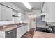 Well-lit kitchen featuring white cabinets, stainless steel appliances, and durable countertops at 36243 Lake Chase Blvd # 102, Zephyrhills, FL 33541