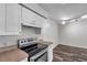 Stylish kitchen featuring a modern stove, white cabinets, and a clean, functional design at 36243 Lake Chase Blvd # 102, Zephyrhills, FL 33541