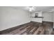 Bright living room boasts hardwood flooring and flows into the kitchen for seamless entertaining at 36243 Lake Chase Blvd # 102, Zephyrhills, FL 33541