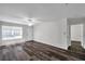 Bright living room boasts hardwood flooring and flows into the kitchen for seamless entertaining at 36243 Lake Chase Blvd # 102, Zephyrhills, FL 33541