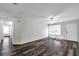 Bright living room boasts hardwood flooring and flows into the kitchen for seamless entertaining at 36243 Lake Chase Blvd # 102, Zephyrhills, FL 33541