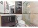 Updated bathroom featuring a vanity with dark wood cabinet, a toilet, a shower with glass door, and modern lighting at 3628 Holiday Lake Dr, Holiday, FL 34691