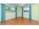 Bedroom with laminate flooring, a ceiling fan, an abundance of natural light from the windows, and light yellow walls at 3628 Holiday Lake Dr, Holiday, FL 34691