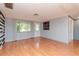 Bright living room with laminate floors, fresh paint, and an abundance of natural light from the front door and windows at 3628 Holiday Lake Dr, Holiday, FL 34691