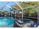 Outdoor pool area with hot tub and screened in patio at 3628 Holiday Lake Dr, Holiday, FL 34691