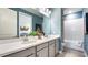 Well-lit bathroom with double vanity, white countertops, and a combined shower and tub at 3840 Consolare Ct, Wesley Chapel, FL 33543