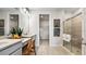 Bathroom with double vanity, lots of counterspace, a glass shower, and a walk-in closet at 3840 Consolare Ct, Wesley Chapel, FL 33543