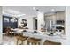 Open-concept kitchen featuring a large island with bar seating, stainless steel appliances, and pendant lighting at 3840 Consolare Ct, Wesley Chapel, FL 33543