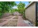 Secluded backyard with brick-paved areas, landscaping, and privacy fencing at 3909 W Lemon St, Tampa, FL 33609