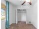 Bedroom features an open closet, bright window and ceiling fan at 3909 W Lemon St, Tampa, FL 33609