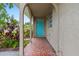 The spacious covered front porch welcomes visitors with decorative tile flooring and a pop of color from the bright turquoise door at 3909 W Lemon St, Tampa, FL 33609