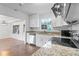 Open kitchen features white cabinets, granite countertops, and stainless steel appliances at 3909 W Lemon St, Tampa, FL 33609
