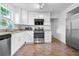 Modern kitchen featuring stainless steel appliances, granite counters, and white cabinets, offering a clean and stylish design at 3909 W Lemon St, Tampa, FL 33609
