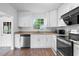 Bright kitchen features white cabinets, granite countertops, and stainless steel appliances at 3909 W Lemon St, Tampa, FL 33609
