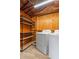 Modern laundry room features a new washer and dryer, and shelving for convenient storage at 3909 W Lemon St, Tampa, FL 33609