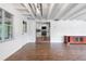 Open living space offers ample light, wood floors, access to the kitchen, and a view of the front yard at 3909 W Lemon St, Tampa, FL 33609