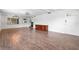 Inviting living room featuring wood floors, a modern light fixture, and white walls, enhancing the sense of spaciousness at 3909 W Lemon St, Tampa, FL 33609