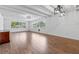 The airy living room is enhanced by wood floors, beamed ceilings, modern light fixtures, and plentiful natural light at 3909 W Lemon St, Tampa, FL 33609