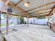 Large wooden back deck with metal roof and a backyard featuring a fountain and landscaping at 4030 Braesgate Ln, Tampa, FL 33624