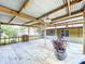 Expansive covered back deck with wooden floorboards and decorative potted plants provides a relaxing outdoor space at 4030 Braesgate Ln, Tampa, FL 33624