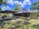 Home exterior with a screened-in porch and open deck, perfect for outdoor relaxation and entertaining at 4030 Braesgate Ln, Tampa, FL 33624