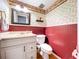 Charming powder room featuring decorative wallpaper and a classic vanity at 4030 Braesgate Ln, Tampa, FL 33624
