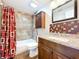 This bathroom features a shower-tub combo with decorative tile and updated vanity at 4030 Braesgate Ln, Tampa, FL 33624