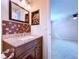 Bathroom boasts a granite countertop vanity, decorative mirror, and stylish tile work at 4030 Braesgate Ln, Tampa, FL 33624