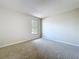 A bright bedroom with neutral carpet and a window, providing a simple and comfortable space at 4030 Braesgate Ln, Tampa, FL 33624