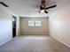 Bedroom with neutral carpet, ceiling fan, and a glimpse into an adjacent space through a doorway at 4030 Braesgate Ln, Tampa, FL 33624