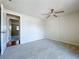 Neutral carpet bedroom with a ceiling fan and an adjacent room, creating a calm atmosphere at 4030 Braesgate Ln, Tampa, FL 33624