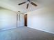 A bright bedroom with neutral carpet, ceiling fan, and closet, offering a clean and comfortable space at 4030 Braesgate Ln, Tampa, FL 33624