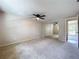 The bedroom includes neutral carpet, mirrored closet doors, and a ceiling fan for added comfort at 4030 Braesgate Ln, Tampa, FL 33624