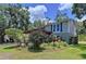 Charming home exterior with a pergola and lush landscaping, creating a welcoming and picturesque setting at 4030 Braesgate Ln, Tampa, FL 33624