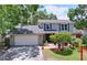 Charming two-story home featuring lush landscaping, a welcoming entrance and a two-car garage at 4030 Braesgate Ln, Tampa, FL 33624